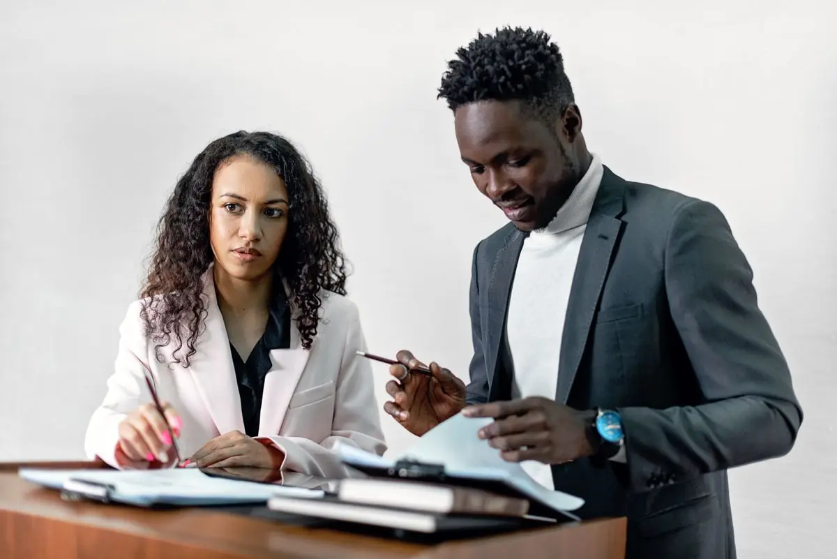 Two advisors reviewing transaction documents