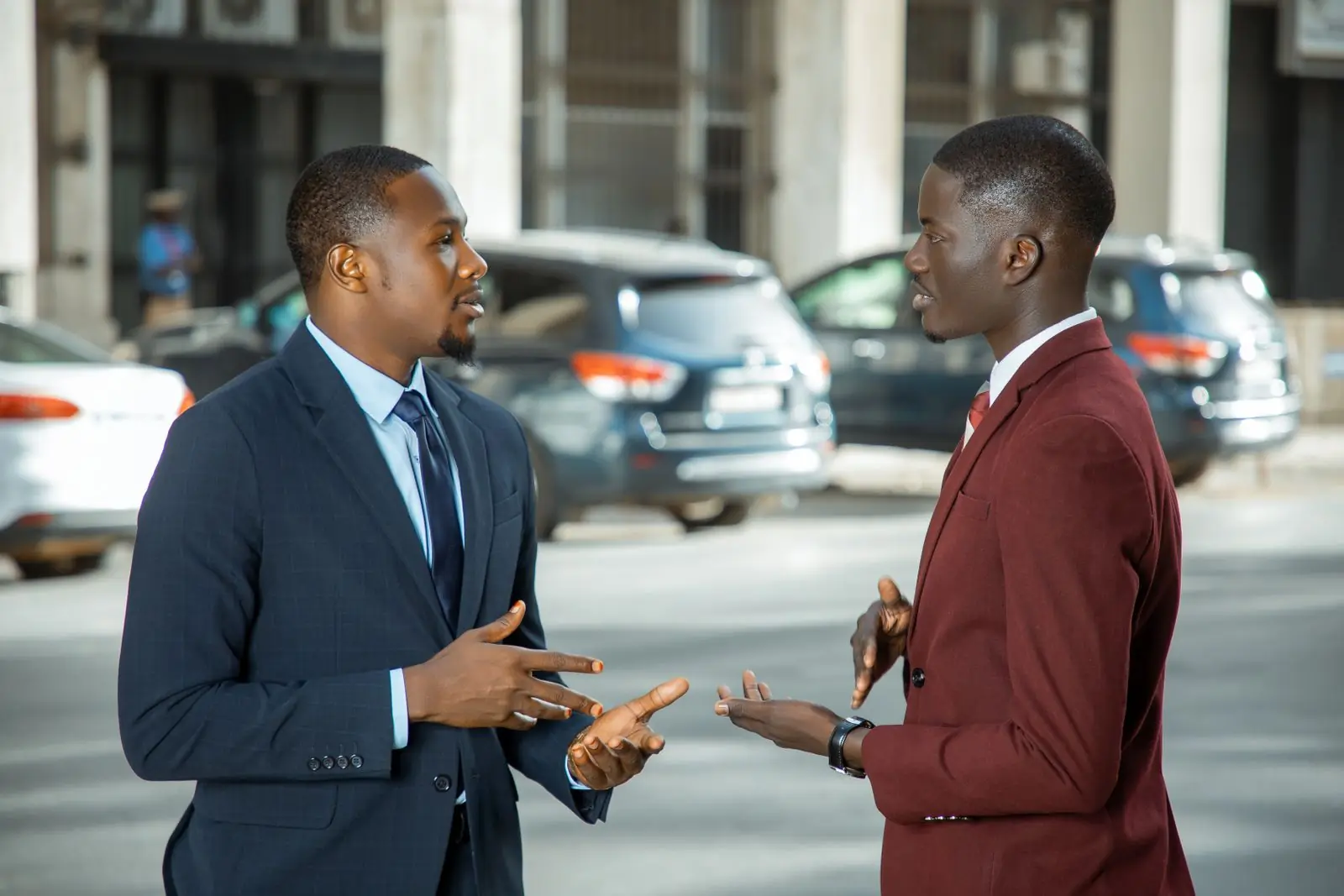 Two advisors in suits in conversation on a city street